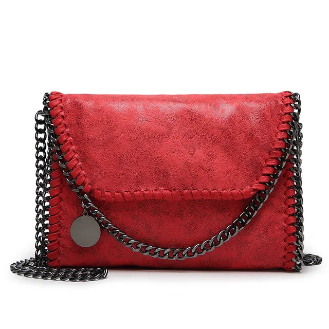 Océane - Suede clutch bag with chain embellishments